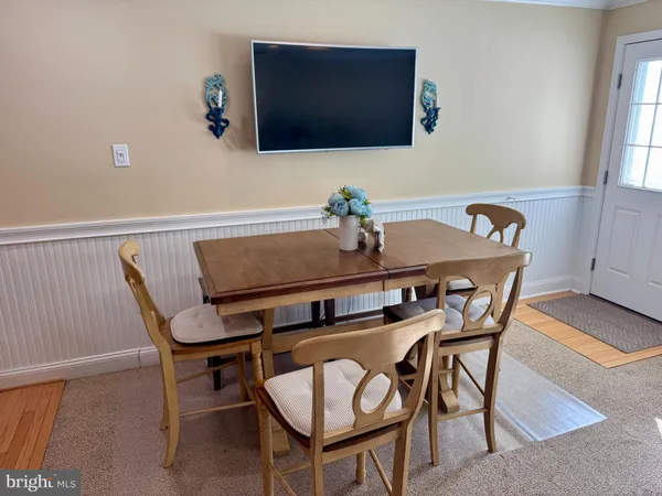 a dining room with furniture and wooden floor
