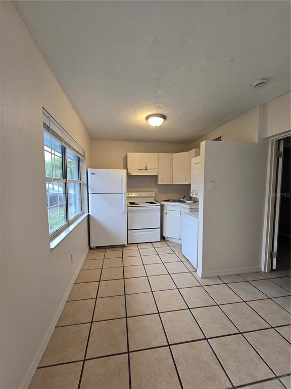 2150 Barbara Drive, Unit 4 St. Cloud, FL 34771 - Photo 6 of 12 a kitchen with stainless steel appliances a refrigerator sink and cabinets