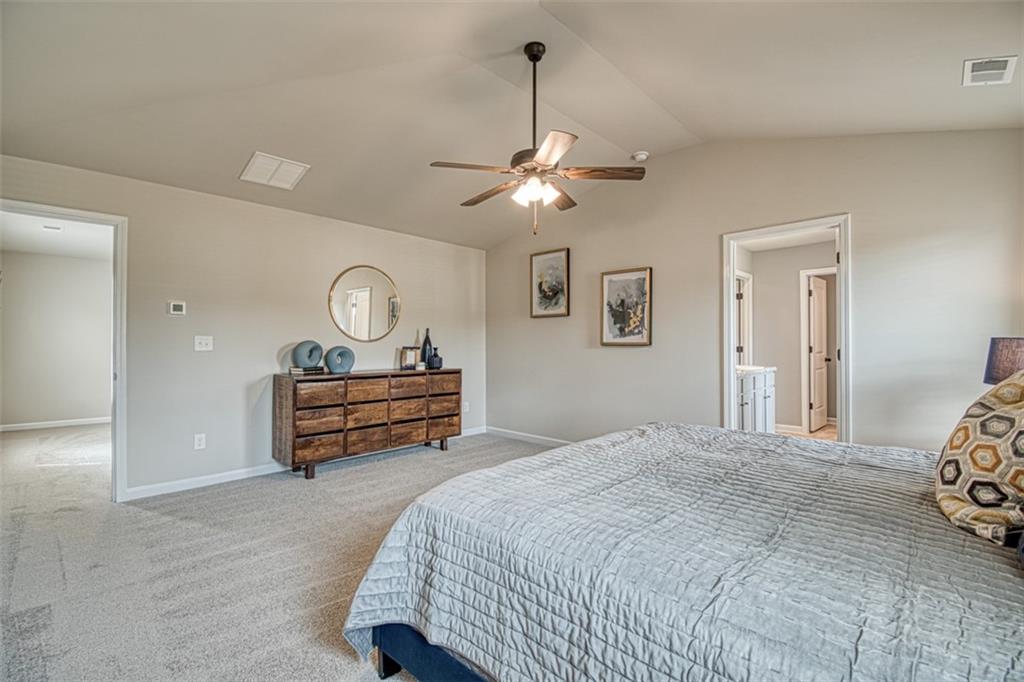 11951 Brightside Parkway Hampton, GA 30228 - Photo 19 of 25 a bedroom with bed and a chandelier