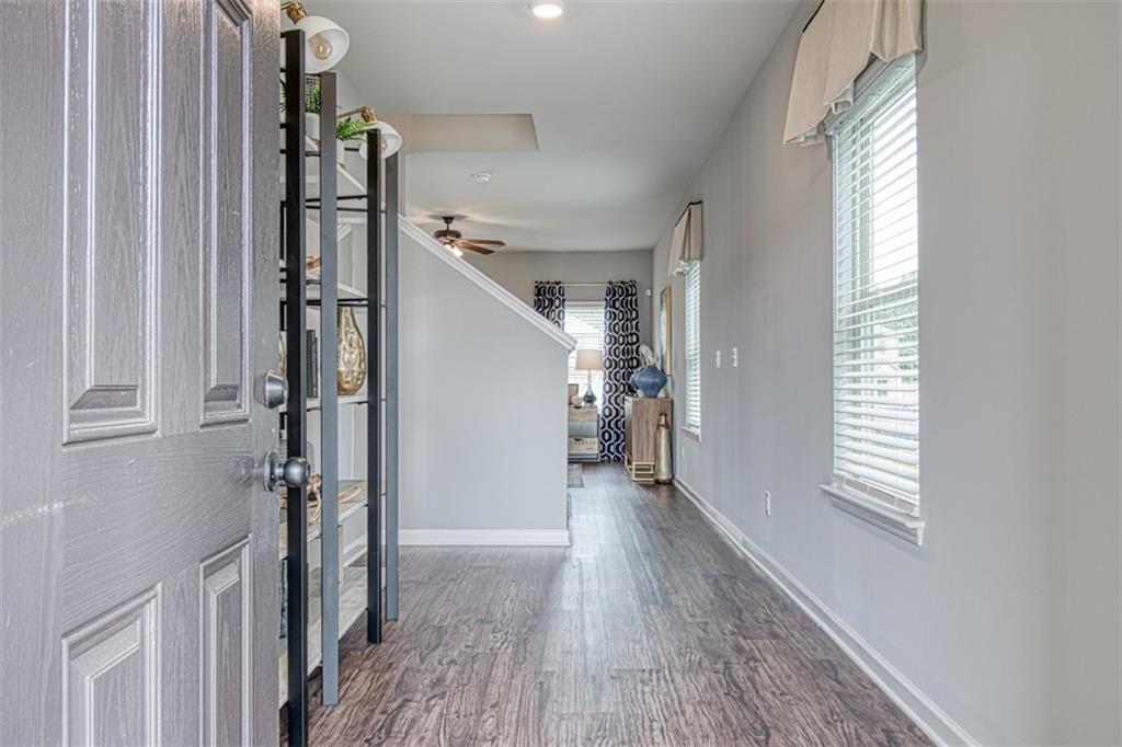 11951 Brightside Parkway Hampton, GA 30228 - Photo 4 of 25 a view of hallway with stairs and wooden floor