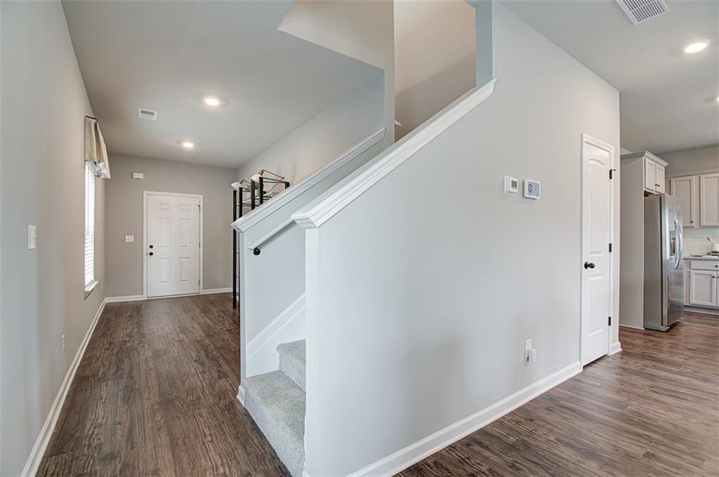 11951 Brightside Parkway Hampton, GA 30228 - Photo 5 of 25 a view of hallway with wooden floor and staircase