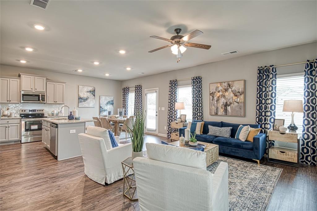 11951 Brightside Parkway Hampton, GA 30228 - Photo 6 of 25 a living room with furniture and a large window