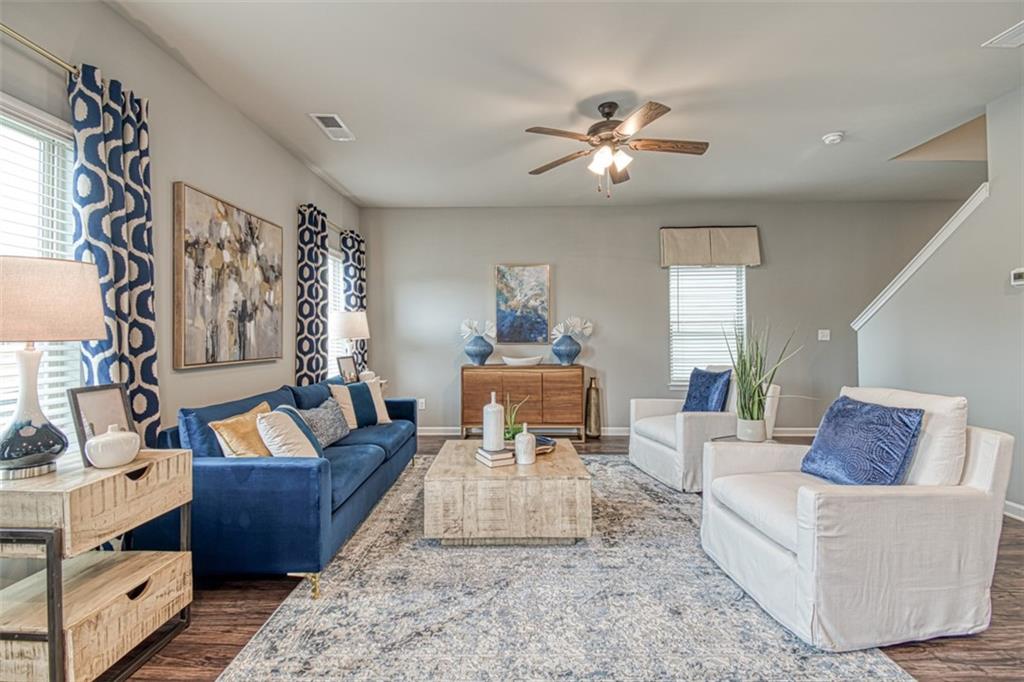 11951 Brightside Parkway Hampton, GA 30228 - Photo 8 of 25 a living room with furniture and a chandelier