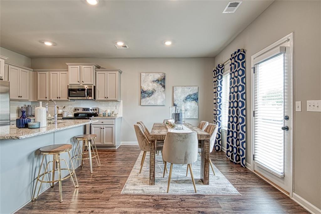 11951 Brightside Parkway Hampton, GA 30228 - Photo 9 of 25 a view of a dining room with furniture and wooden floor