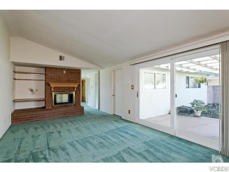805 West Roderick Avenue Oxnard, CA 93030 - Photo 12 of 24 a view of an empty room with a fireplace and a window