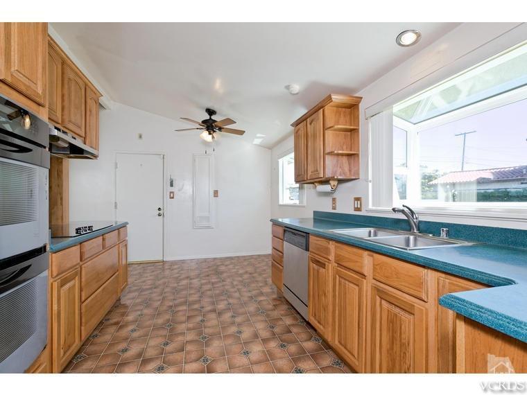 805 West Roderick Avenue Oxnard, CA 93030 - Photo 8 of 24 a kitchen with granite countertop a sink cabinets and window