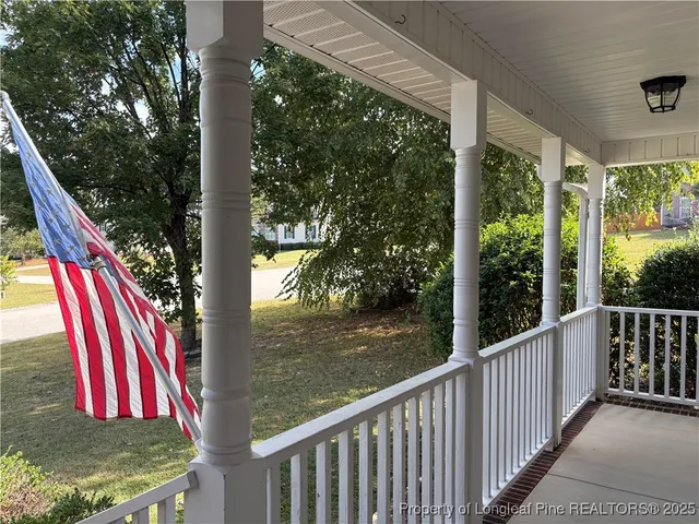 a view of deck with a floor to ceiling window and wooden fence