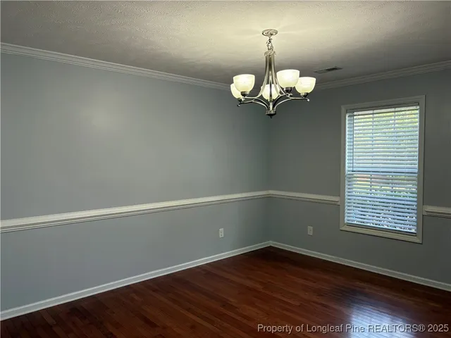 a view of a room with wooden floor and a window