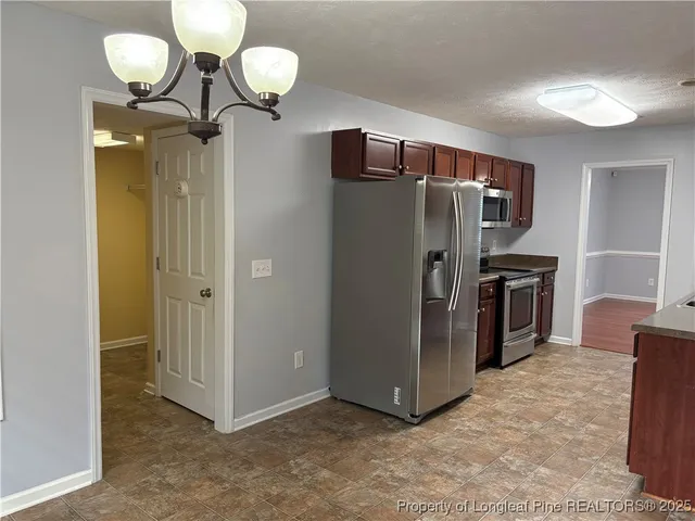 a view of a kitchen with a refrigerator a sink and dishwasher