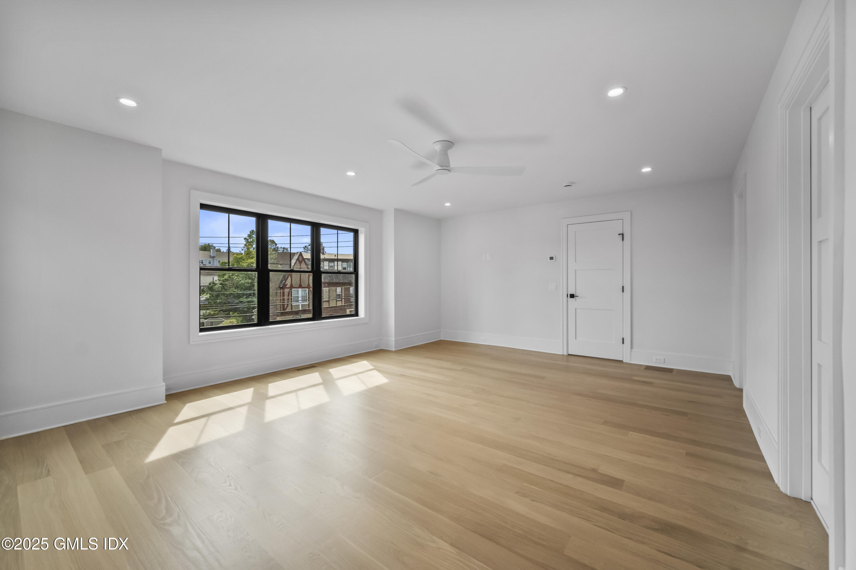 71 Old Field Point Road Greenwich, CT 06830 - Photo 14 of 33 a view of an empty room with a window and wooden floor