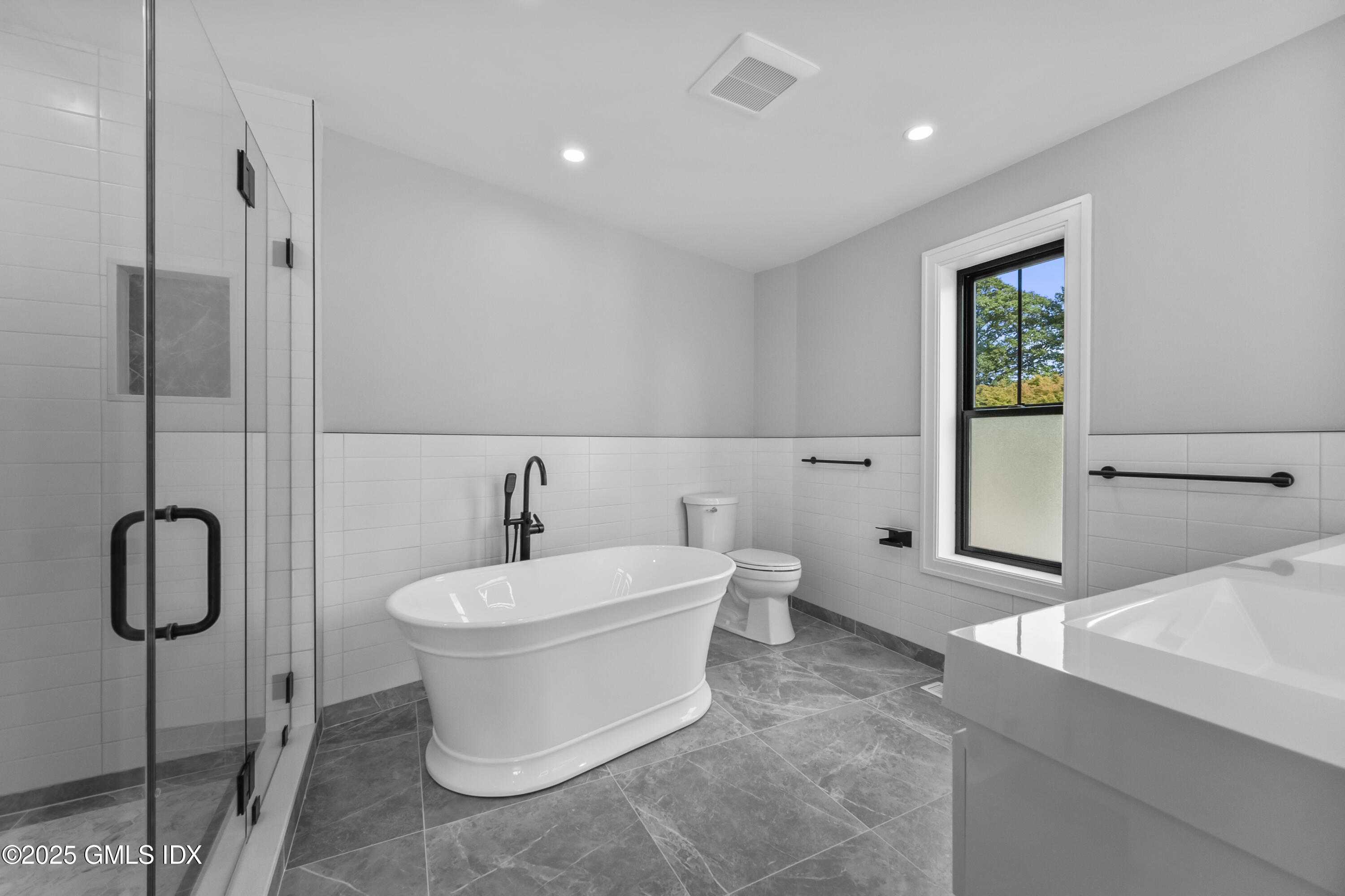 71 Old Field Point Road Greenwich, CT 06830 - Photo 17 of 33 a bathroom with a toilet sink and shower