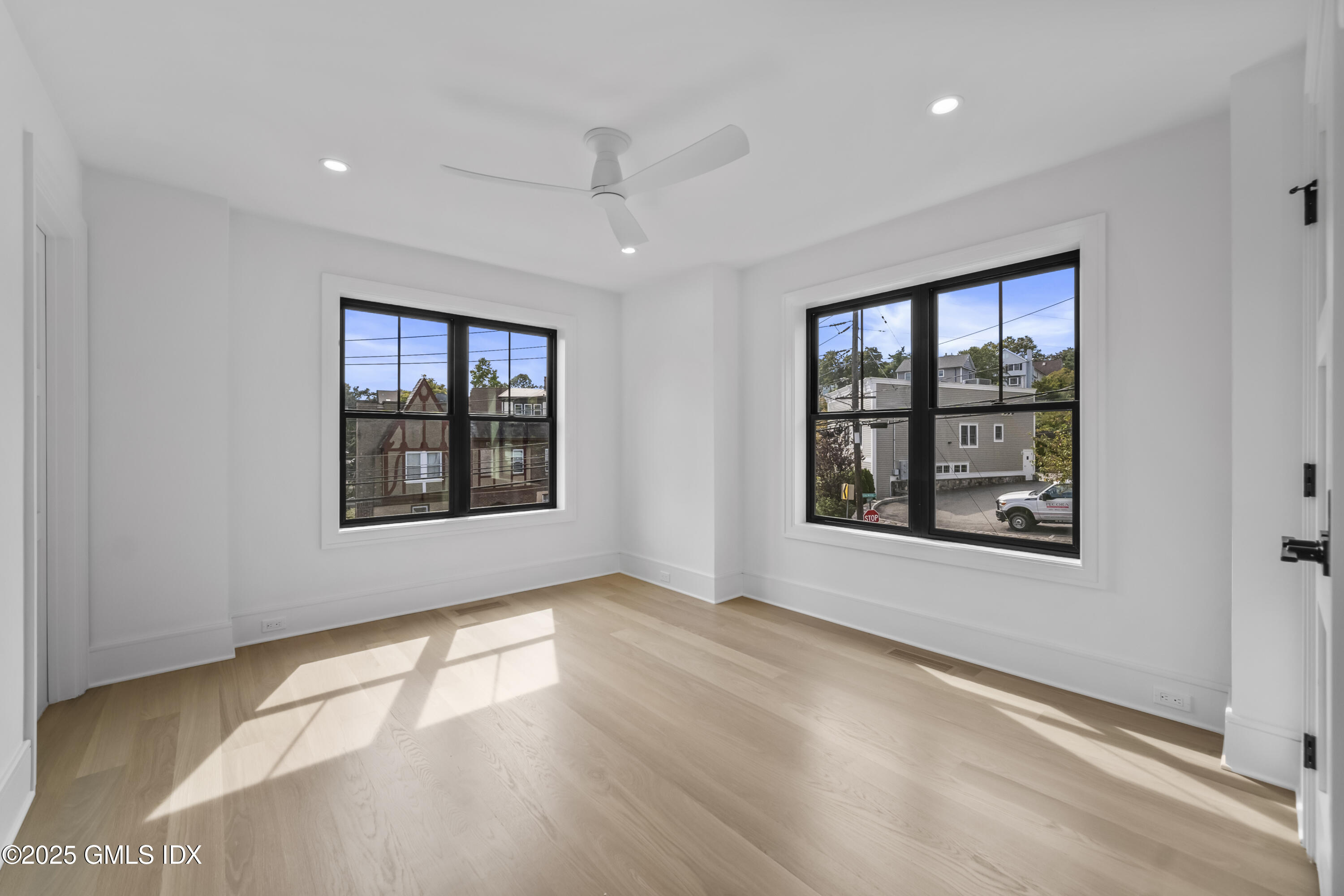 71 Old Field Point Road Greenwich, CT 06830 - Photo 19 of 33 a view of an empty room with a window and wooden floor