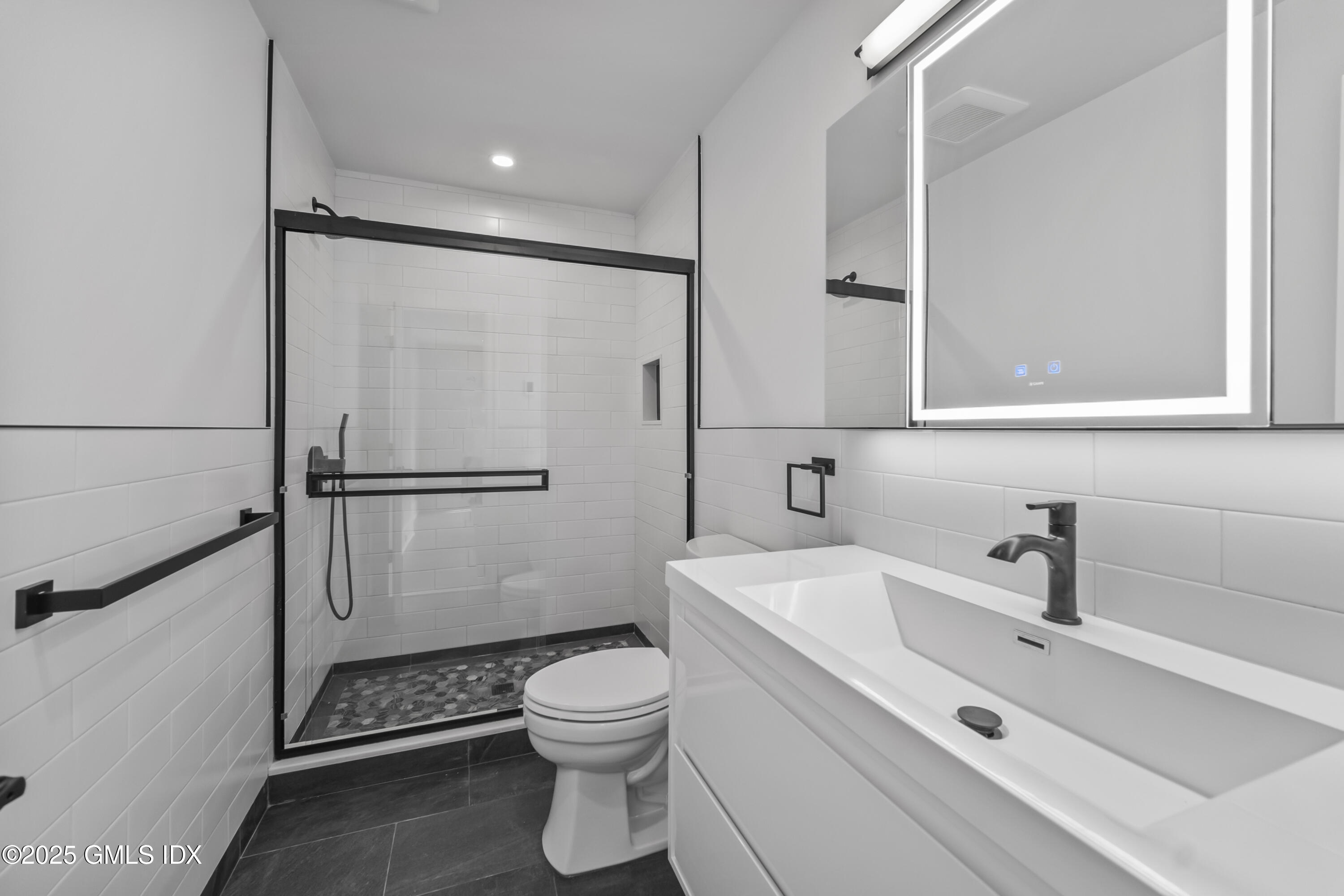 71 Old Field Point Road Greenwich, CT 06830 - Photo 23 of 33 a white toilet sitting next to a bathroom sink