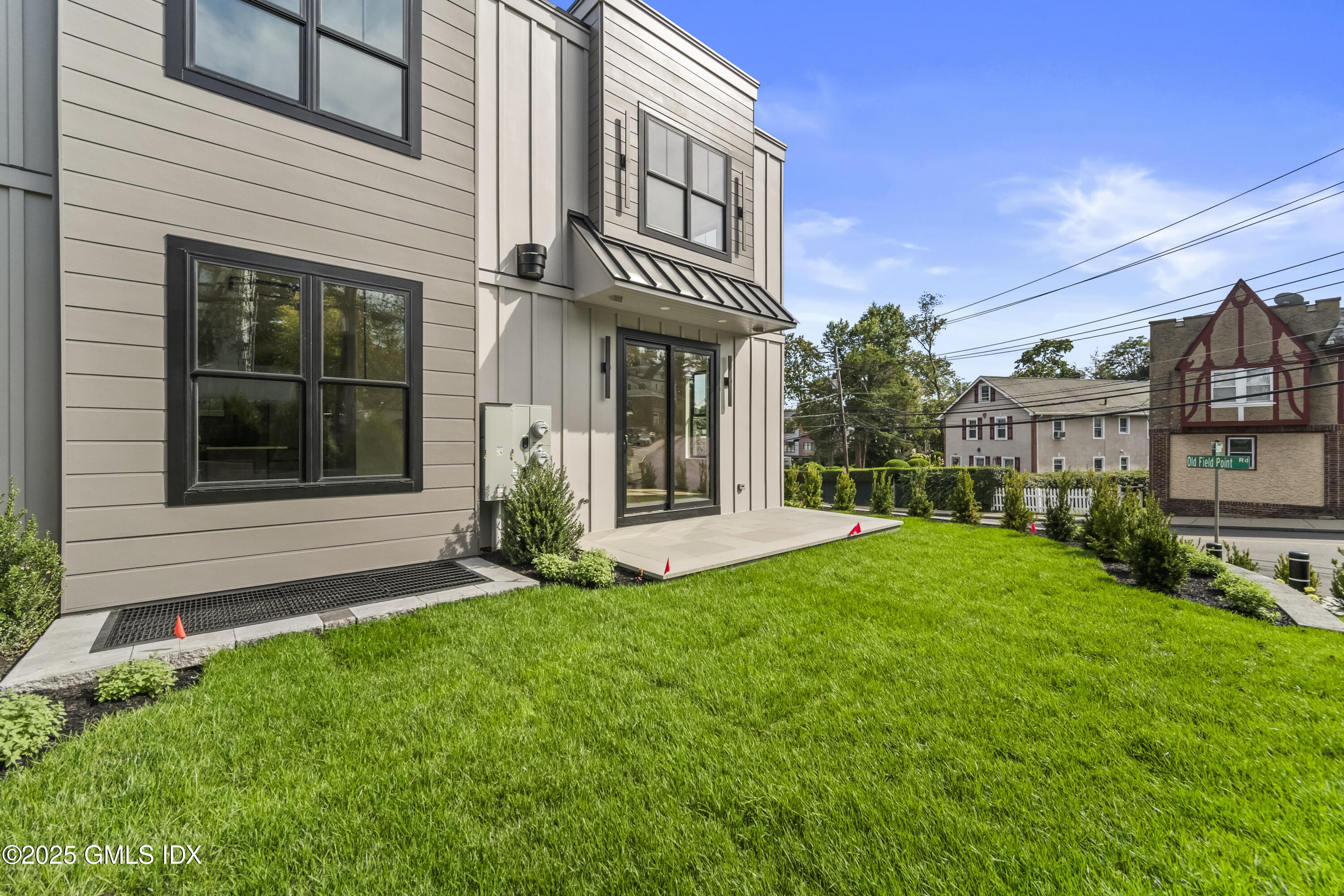 71 Old Field Point Road Greenwich, CT 06830 - Photo 27 of 33 a view of a house with a yard and plants