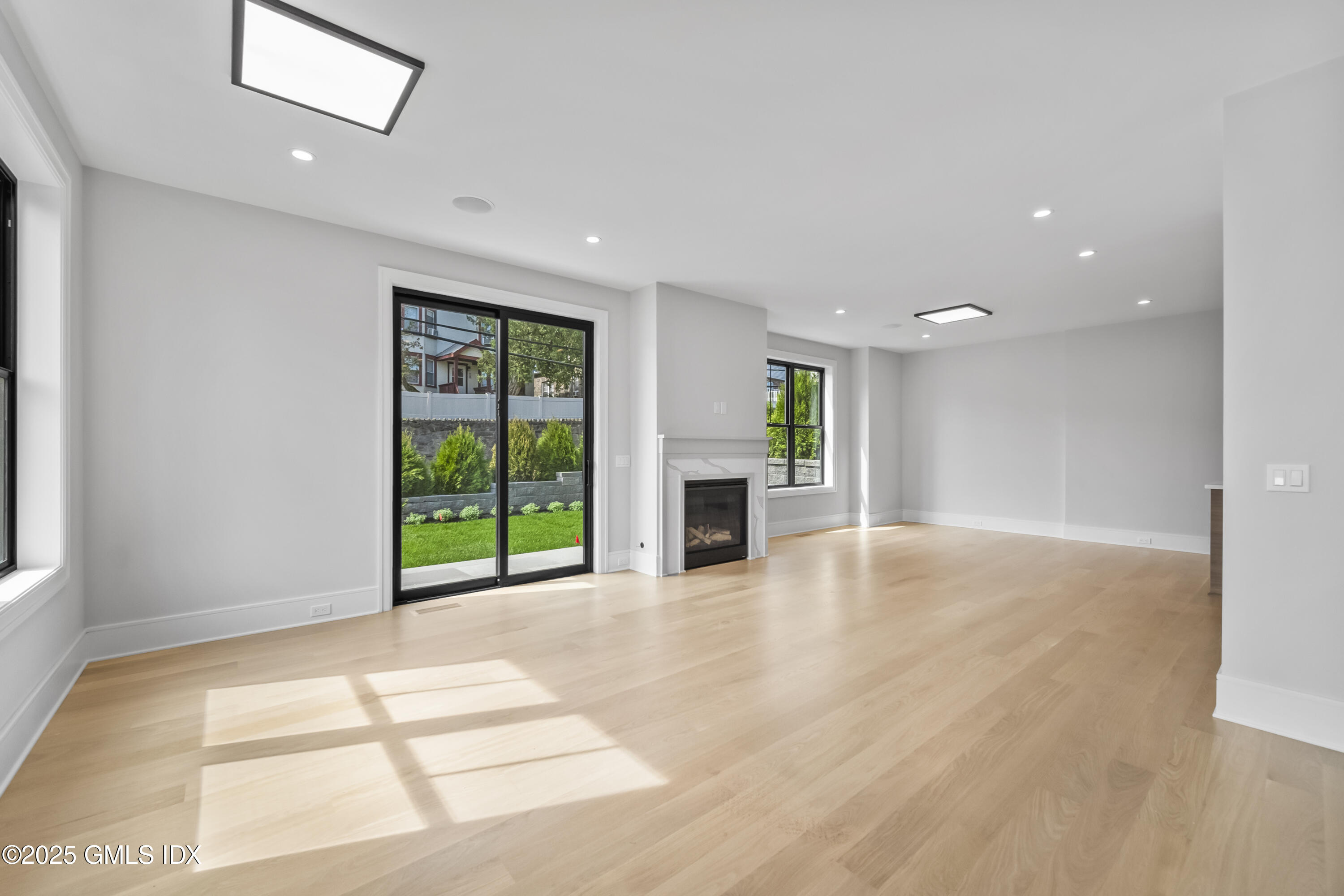 71 Old Field Point Road Greenwich, CT 06830 - Photo 3 of 33 a view of an empty room with a window and fire place