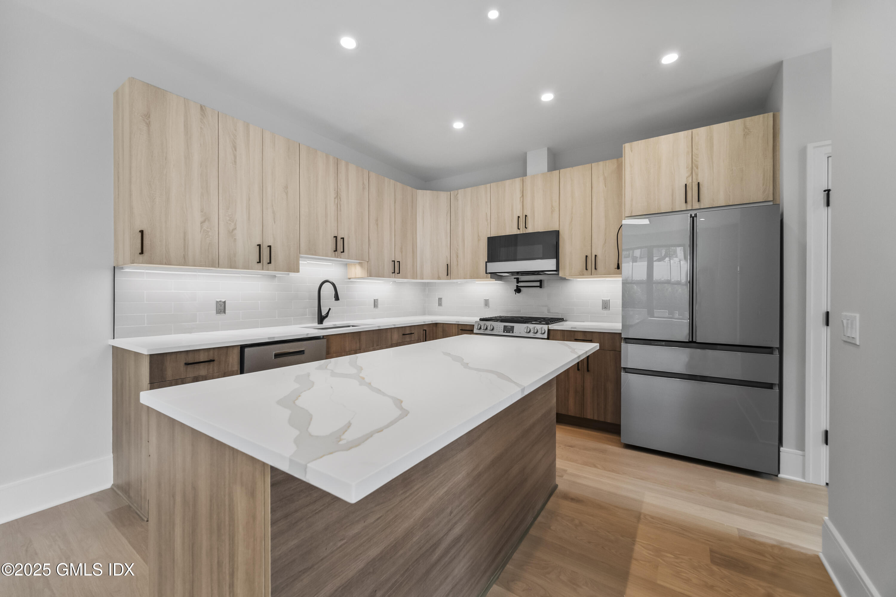 71 Old Field Point Road Greenwich, CT 06830 - Photo 7 of 33 a kitchen with stainless steel appliances a refrigerator sink and microwave