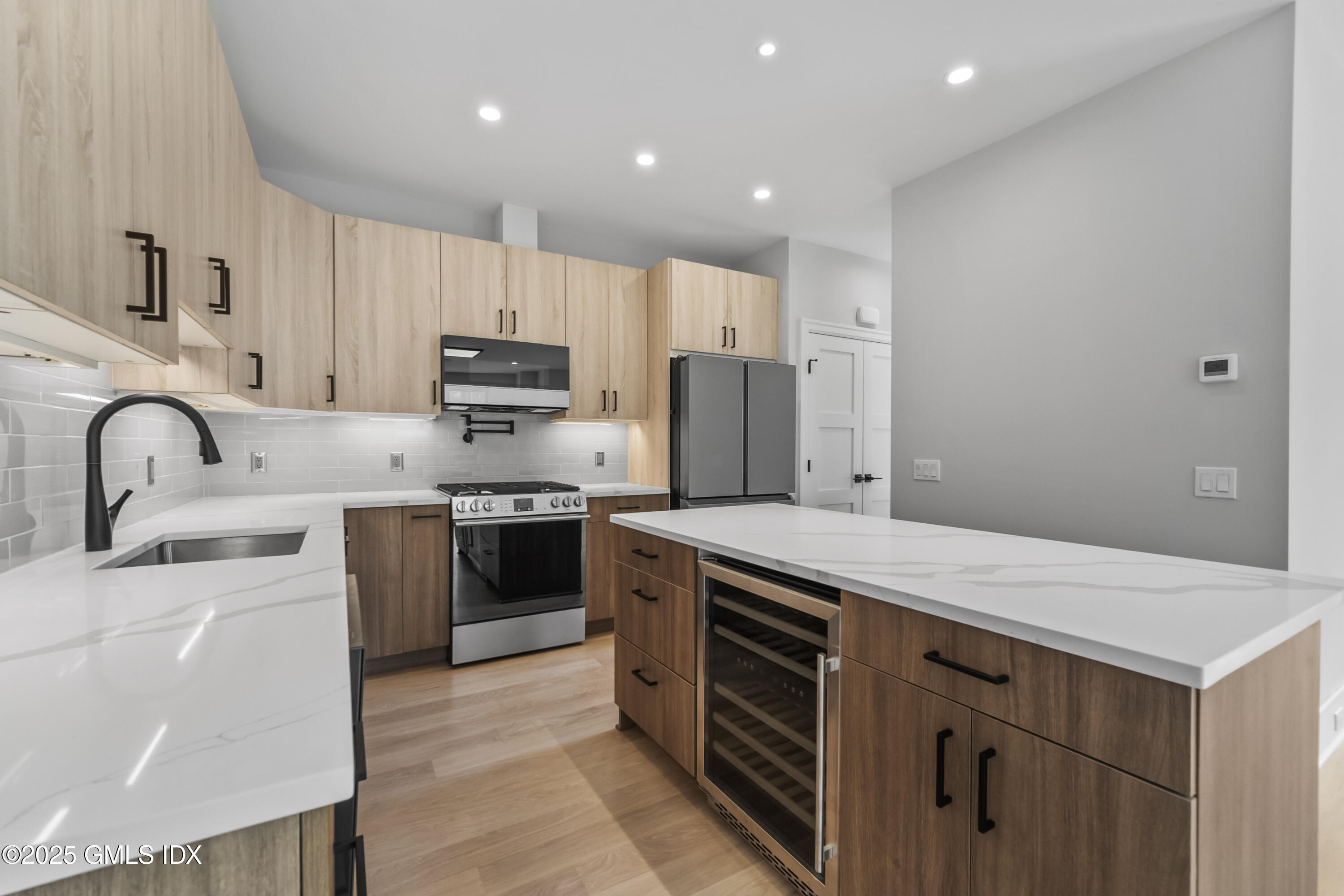 71 Old Field Point Road Greenwich, CT 06830 - Photo 8 of 33 a kitchen with a sink a stove and refrigerator