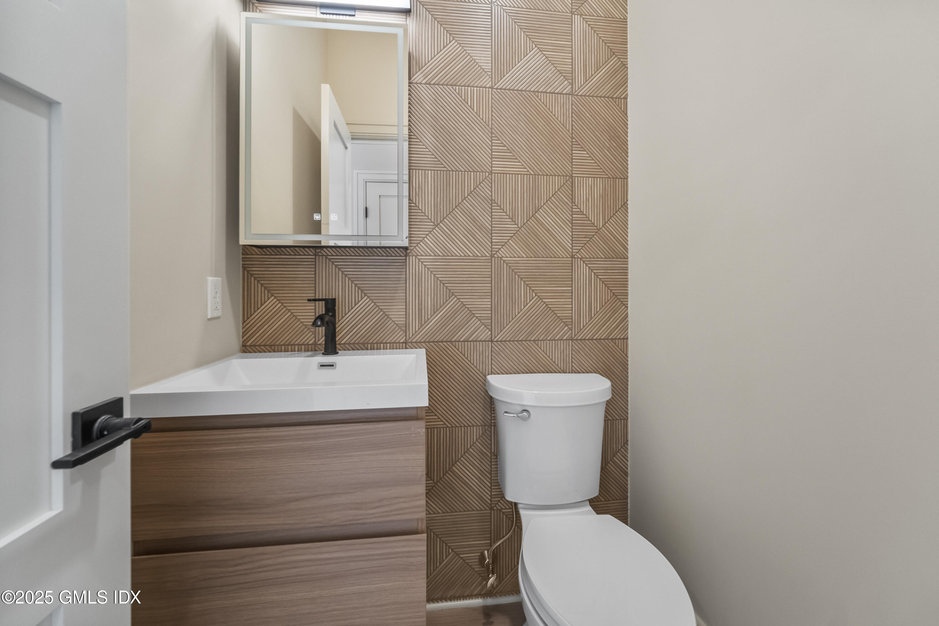 71 Old Field Point Road Greenwich, CT 06830 - Photo 9 of 33 a bathroom with a toilet sink and mirror