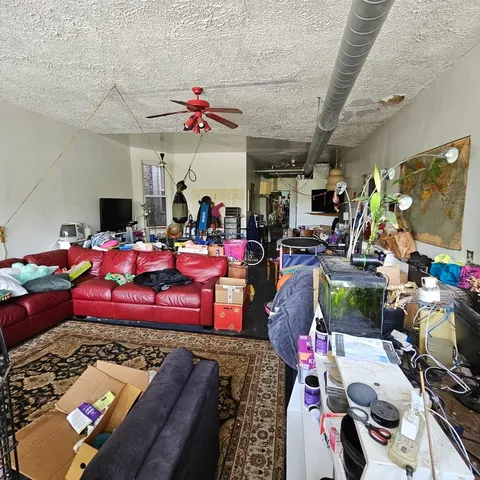 a bedroom with furniture and a flat screen tv