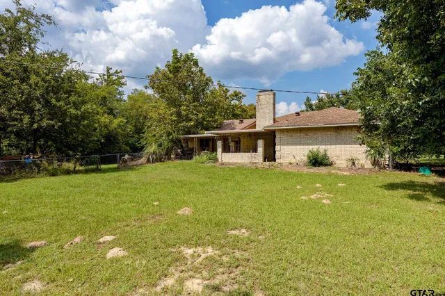 a front view of house with yard and trees