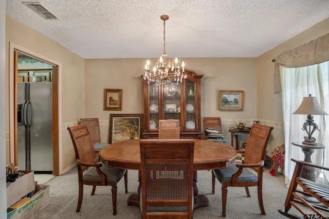 a view of a dining room with furniture and window