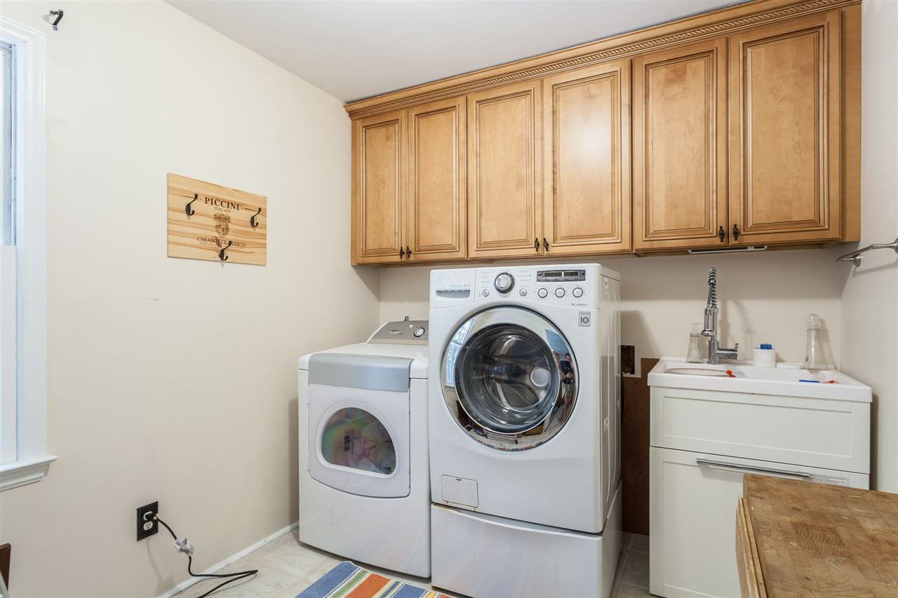 8709 Kenilworth Drive Raleigh, NC 27613 - Photo 17 of 30 has a large utility tub and built in cabinets Laundry Room