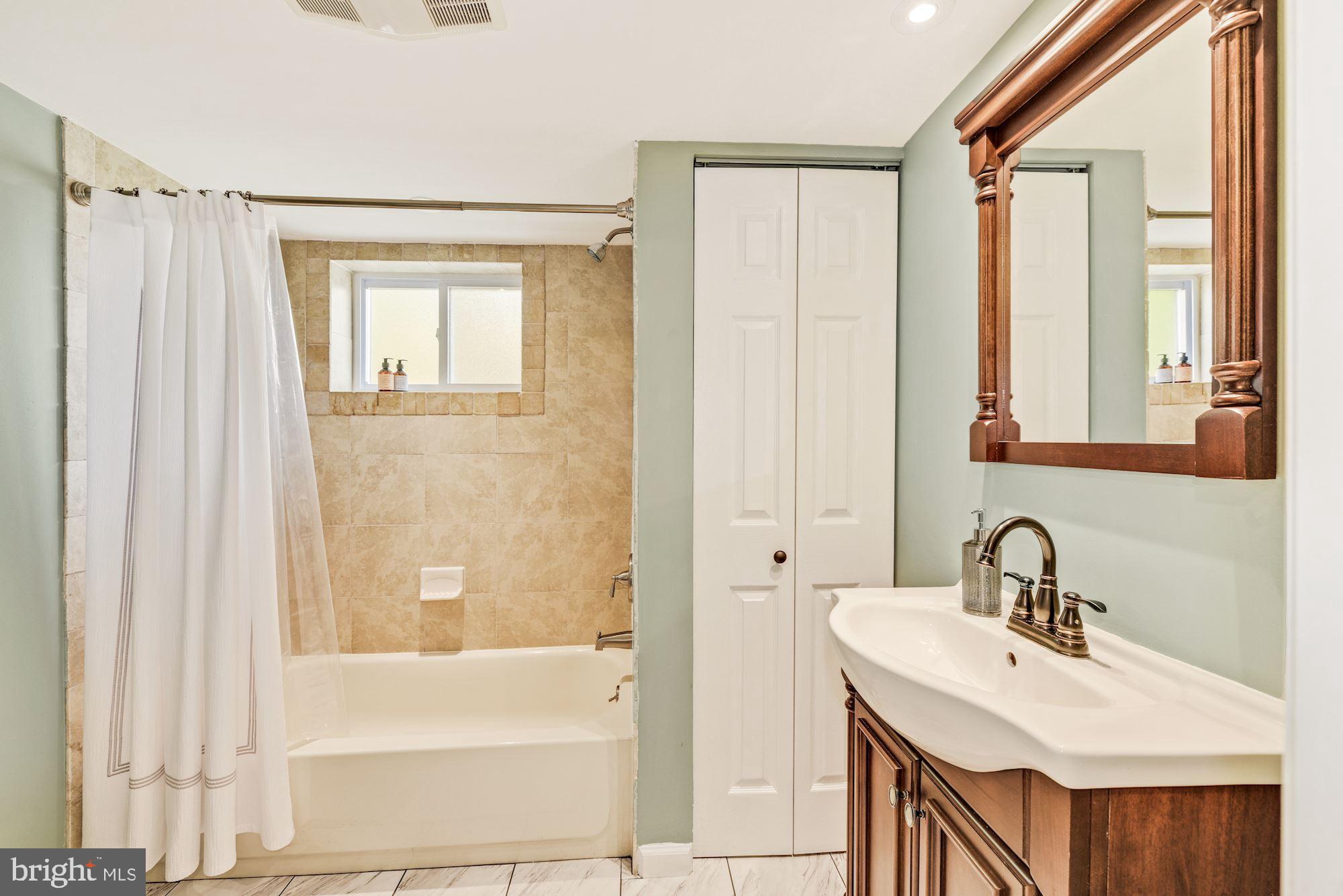 12302 Dewey Road Silver Spring, MD 20906 - Photo 16 of 26 LL Full Bath w/ Tub Shower & New Vinyl Tile Floors