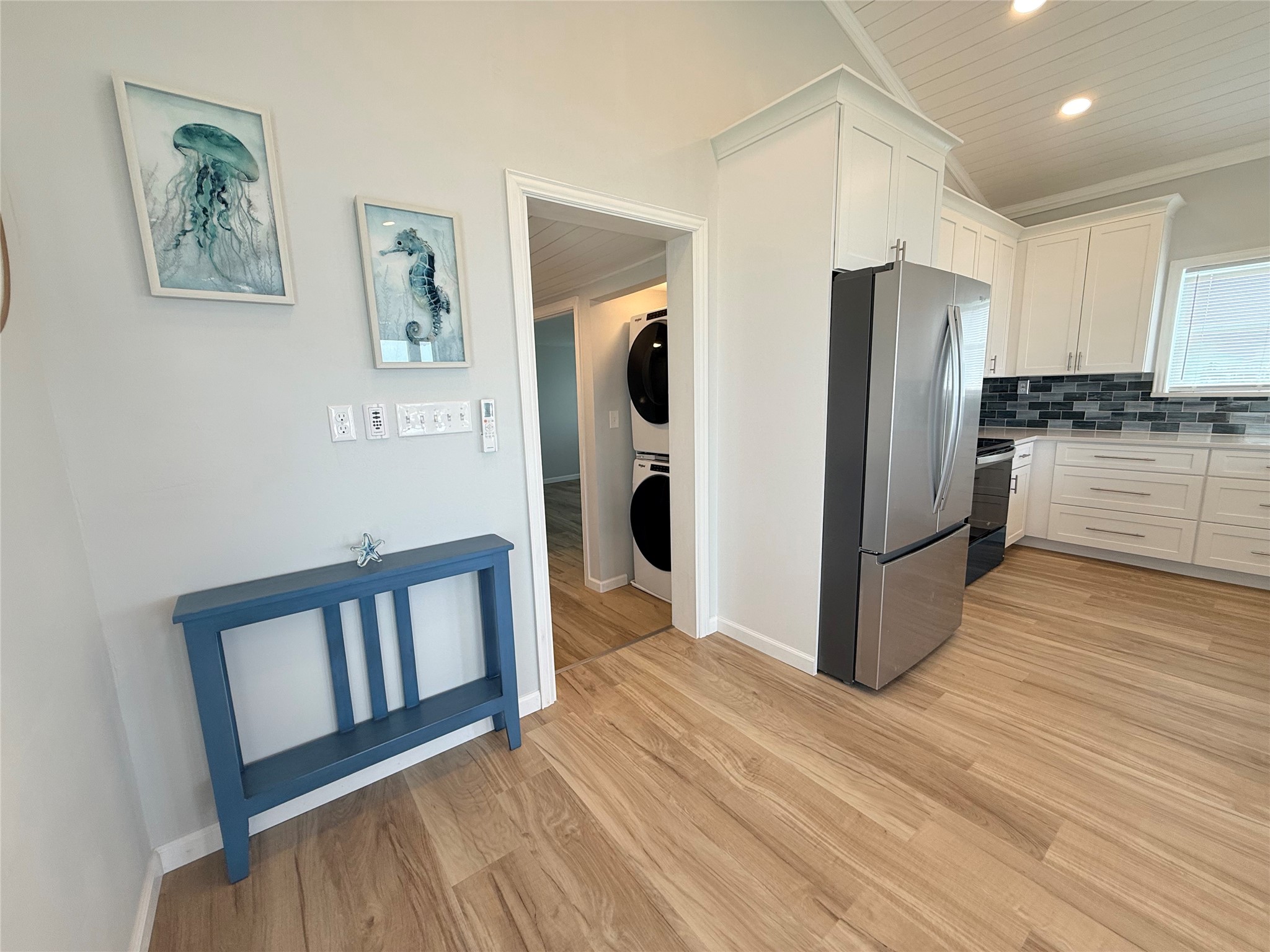 2154 County Road 230 Sargent, TX 77414 - Photo 20 of 30 a kitchen with stainless steel appliances a refrigerator and a wooden floor