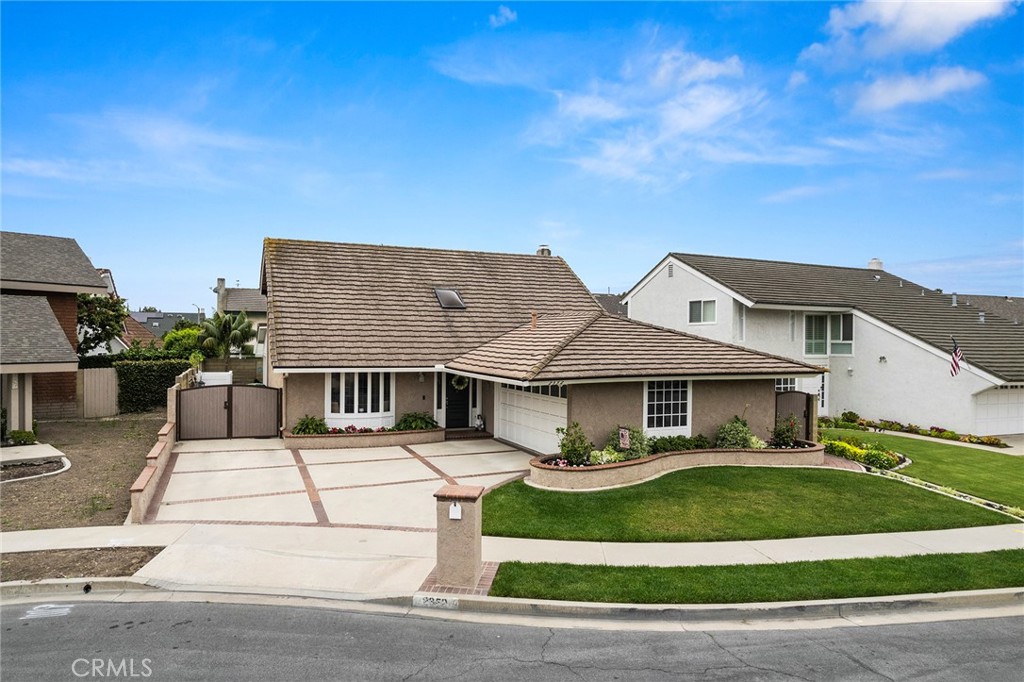 a view of house with yard and entertaining space