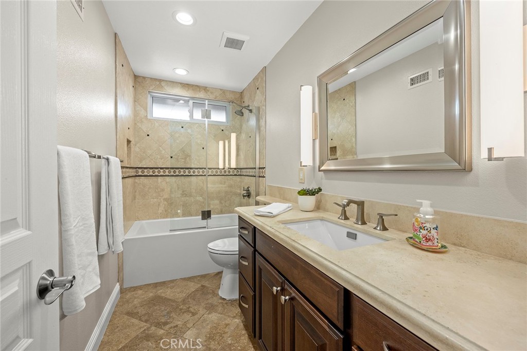 2352 Caper Tree Drive Tustin, CA 92780 - Photo 13 of 29 a bathroom with a granite countertop sink mirror vanity bathtub and toilet