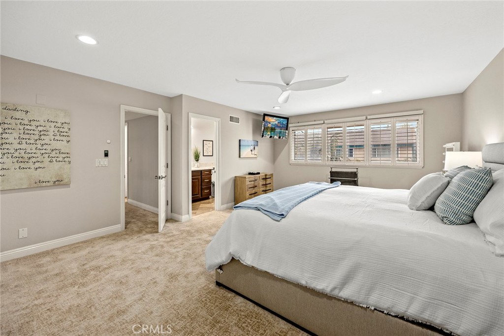 2352 Caper Tree Drive Tustin, CA 92780 - Photo 14 of 29 a bedroom with a large bed and ceiling fan