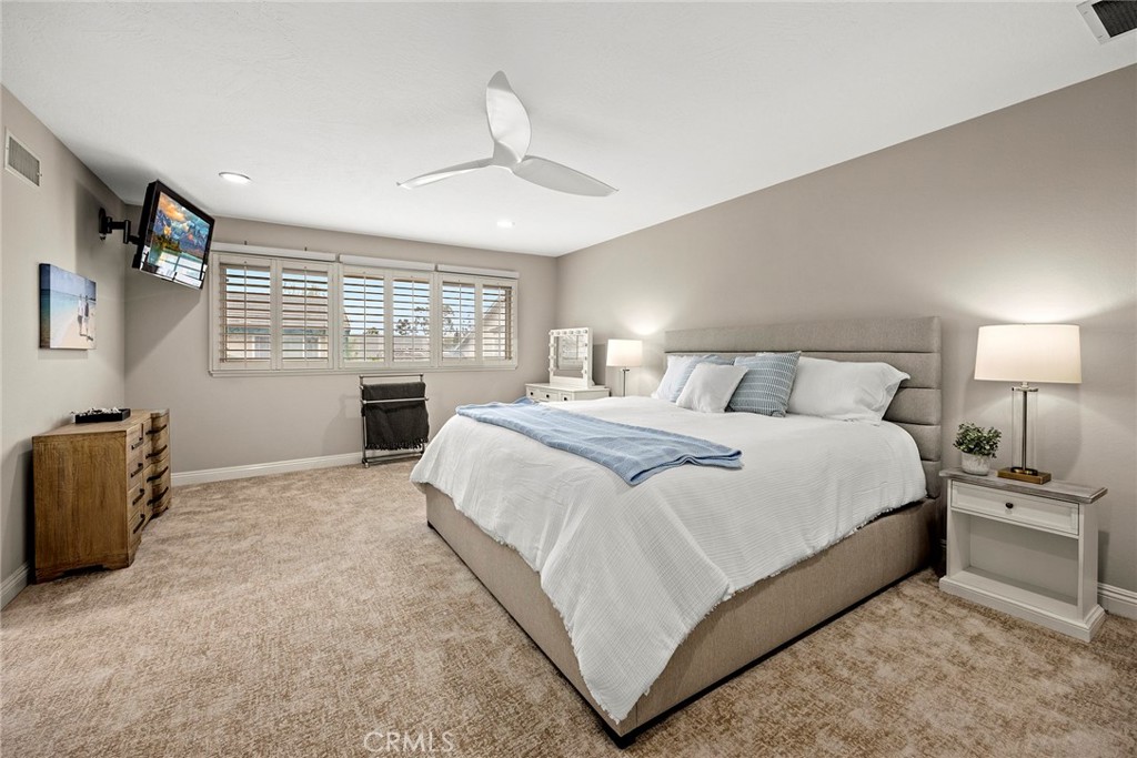 2352 Caper Tree Drive Tustin, CA 92780 - Photo 15 of 29 a bedroom with a large bed and a chandelier