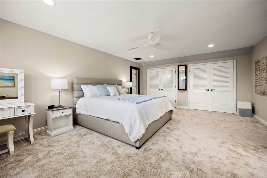 2352 Caper Tree Drive Tustin, CA 92780 - Photo 16 of 29 a bedroom with a large bed and a chandelier