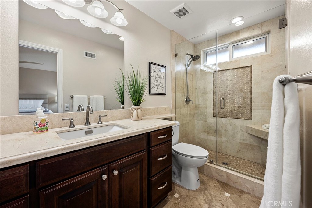 2352 Caper Tree Drive Tustin, CA 92780 - Photo 17 of 29 a bathroom with a double vanity sink mirror double shower and a toilet
