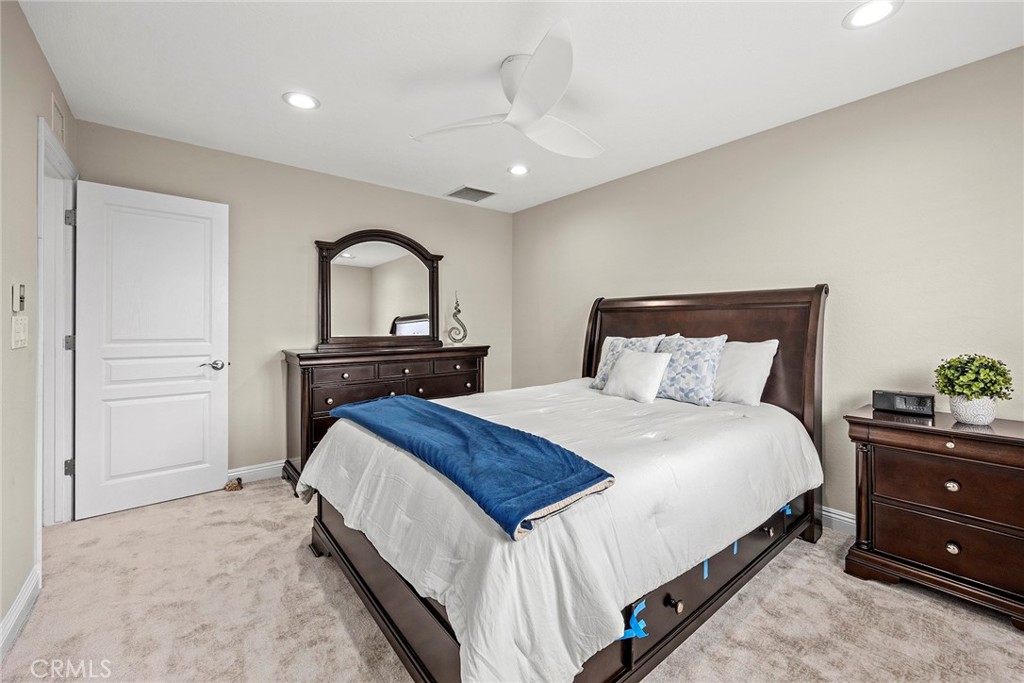 2352 Caper Tree Drive Tustin, CA 92780 - Photo 19 of 29 a bedroom with a bed and a dresser