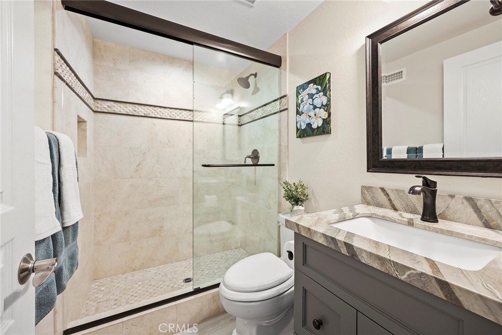2352 Caper Tree Drive Tustin, CA 92780 - Photo 20 of 29 a bathroom with a granite countertop sink toilet and shower