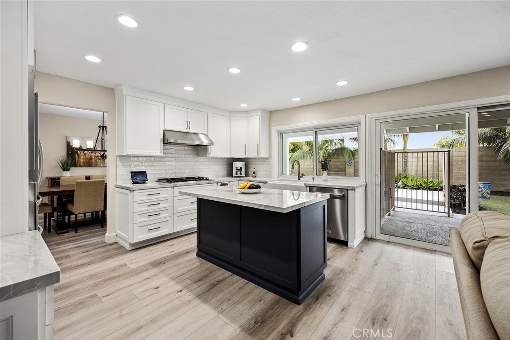 2352 Caper Tree Drive Tustin, CA 92780 - Photo 6 of 29 a kitchen with stainless steel appliances sink stove and cabinets