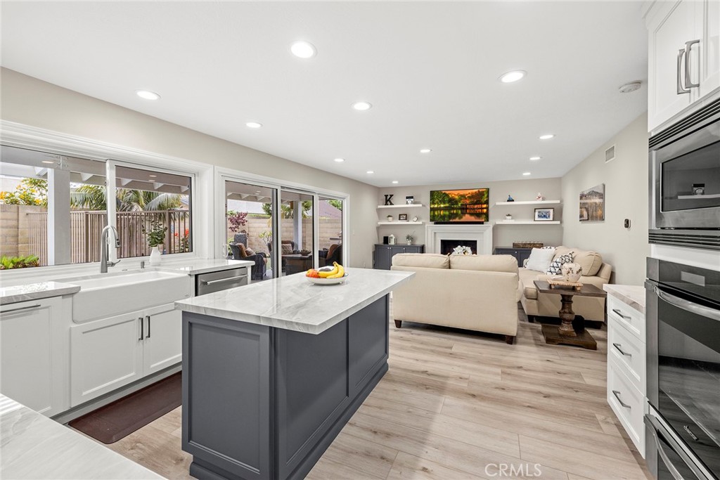 2352 Caper Tree Drive Tustin, CA 92780 - Photo 8 of 29 a large white kitchen with a large window and stainless steel appliances
