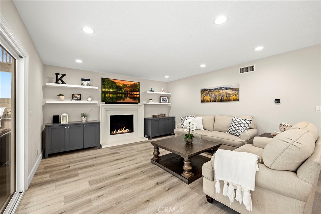 2352 Caper Tree Drive Tustin, CA 92780 - Photo 9 of 29 a living room with furniture a fireplace and a flat screen tv