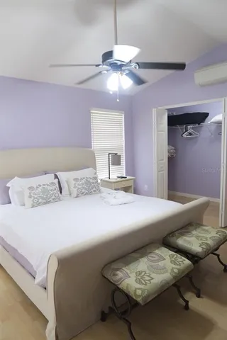 a bedroom with a bed and chandelier