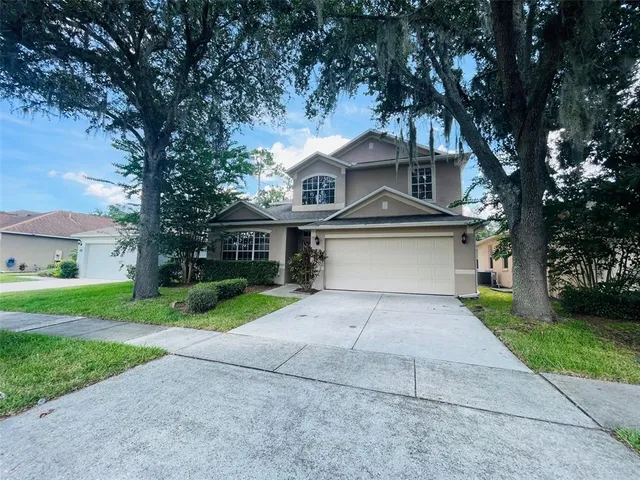 a front view of a house with a yard and garage