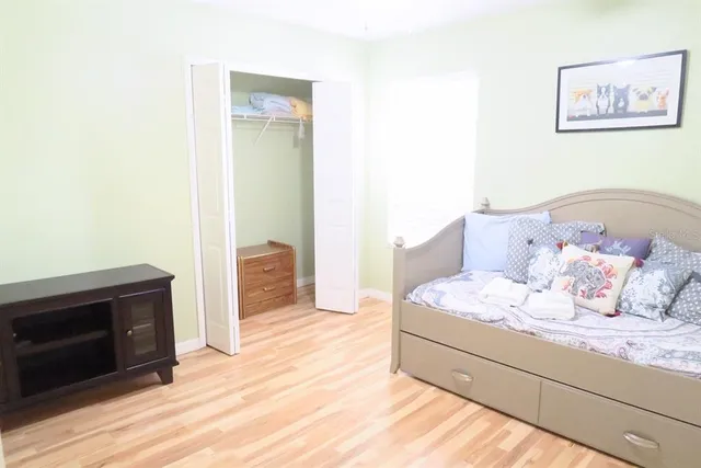 a spacious bedroom with a bed and a fireplace