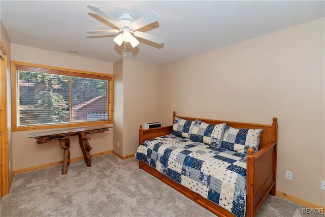 a bed room with two beds and a large window