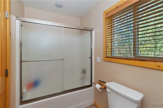 a bathroom with a shower and a toilet