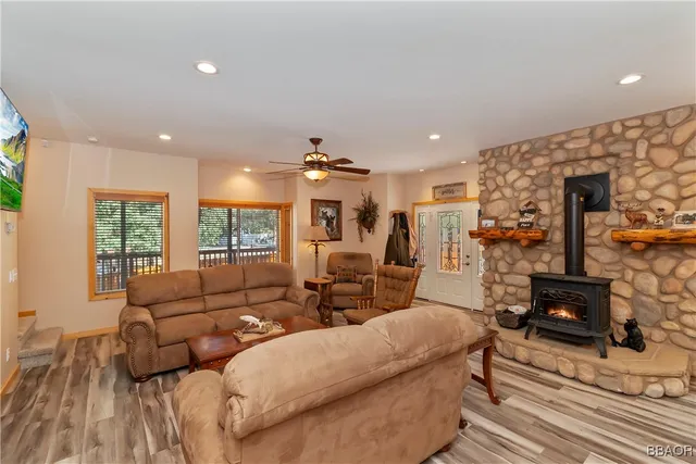 a living room with furniture kitchen view and a large window