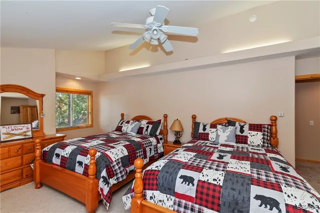 a bedroom with two beds and a chandelier