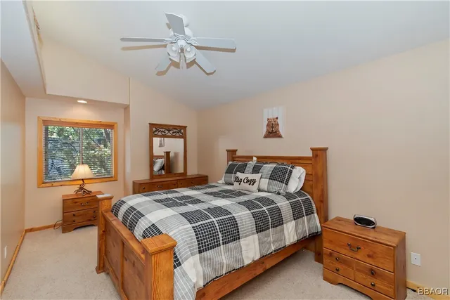 a bedroom with a bed dresser and a window