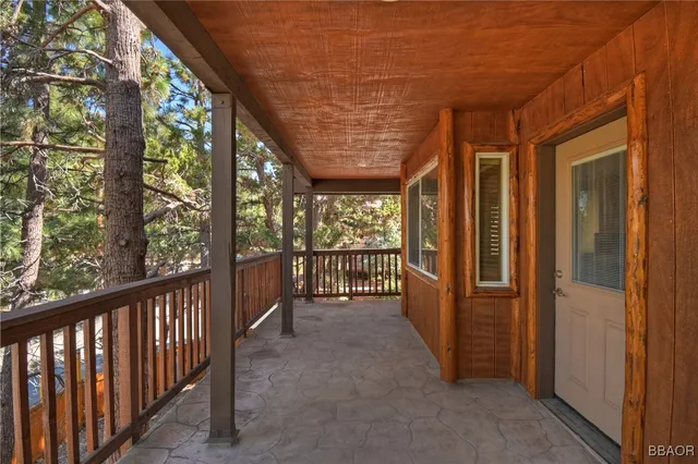 a view of a porch with wooden floor and outdoor space