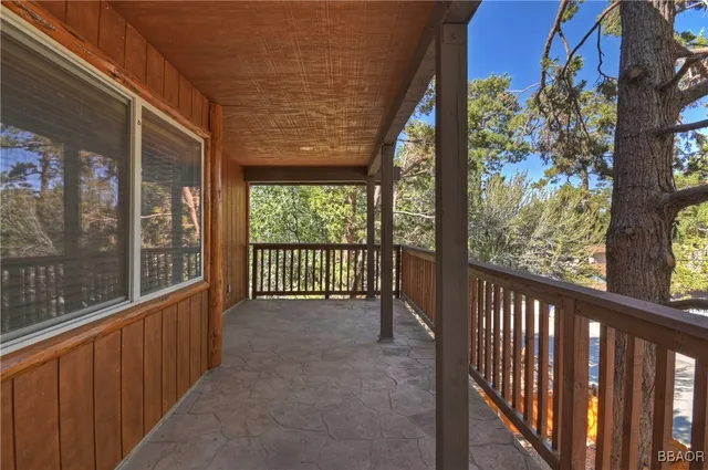 a view of a porch with wooden floor and roof