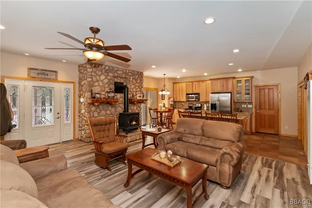 a living room with furniture kitchen view and a chandelier